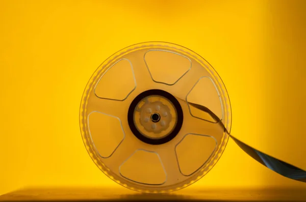 Photo of magnetic tape reel on yellow background