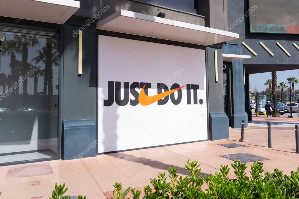BARCELONA, SPAIN - MARCH 30, 2021: NIKE store sign with JUST DO IT logo