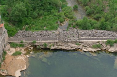 Small lake and river under the dam
