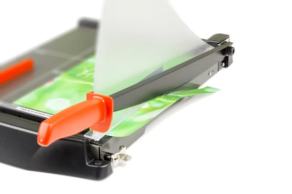 Cutting paper with trimmer on white — Stock Photo, Image