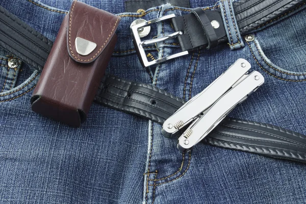 Blue jeans with stainless multitool knife — Stock Photo, Image