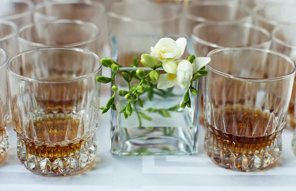 Whisky in een glas en delicate bloem — Stockfoto