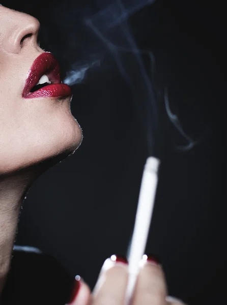 Concept photo of a woman smoking a cigarette. — Stock Photo, Image