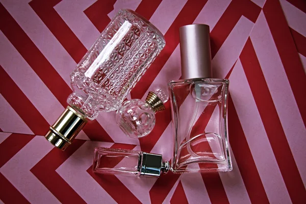 Bottle with perfumes on a pink background — Stock Photo, Image