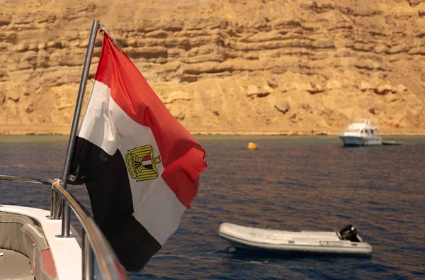 Egyptian flag on the background of the sea and mountains