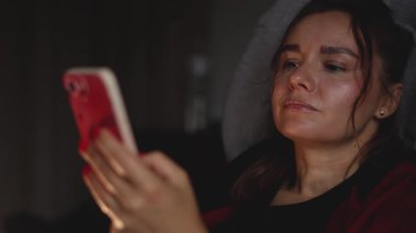 A woman is aimlessly surfing social media.