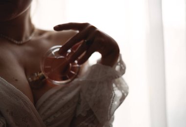 A beautiful model and a bottle of perfume