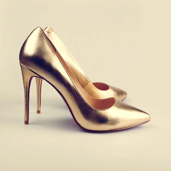Par dorado de zapatos de mujer modernos y de moda en estudio —  Fotos de Stock