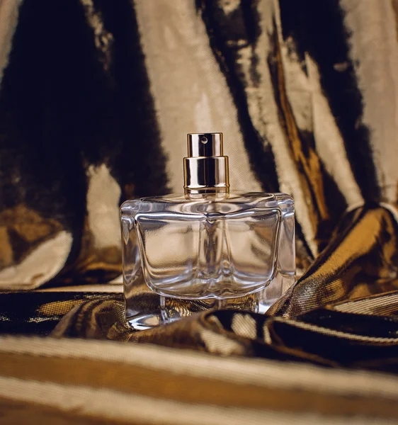 Botella de perfume en tonos dorados — Foto de Stock