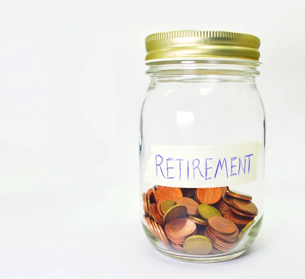 Coins in bottle with retirement plan label on white background — Stock Photo, Image