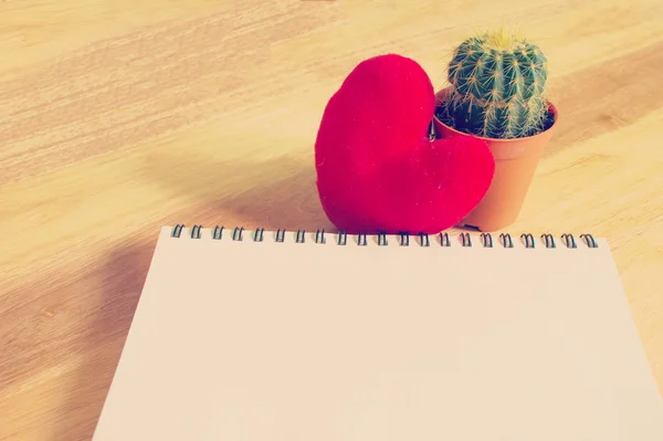 Notebook with heart and cactus on wooden background — Stock Photo, Image