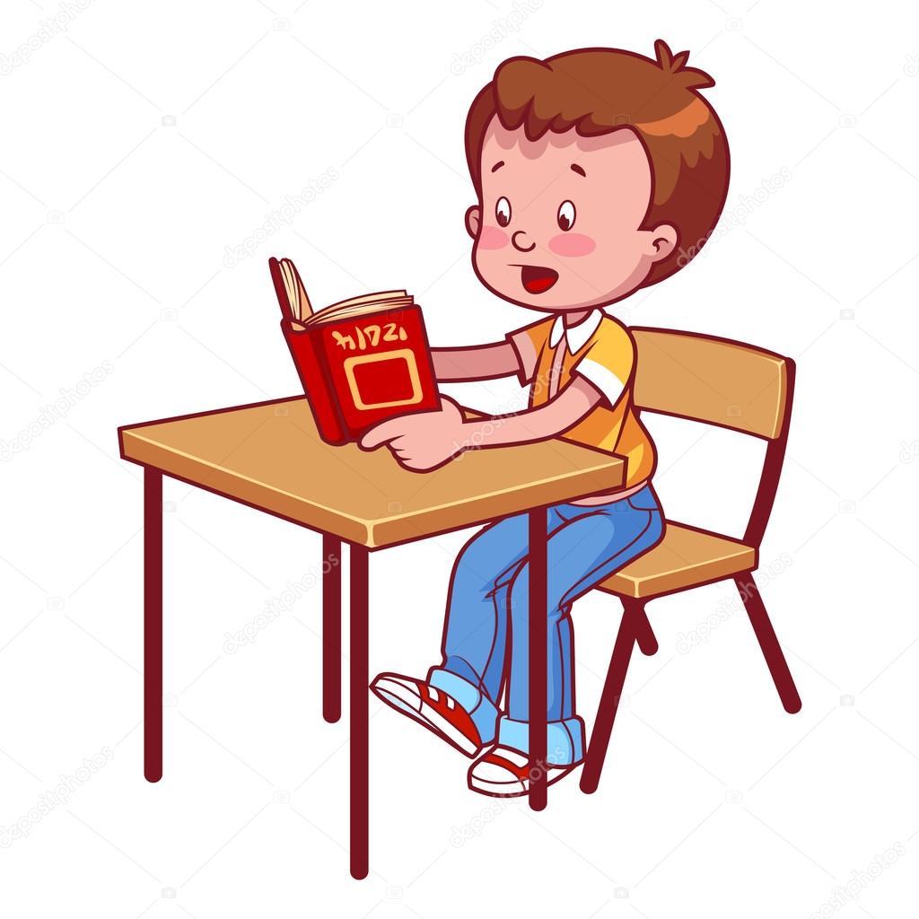 Cute schoolboy behind a school desk reading a book
