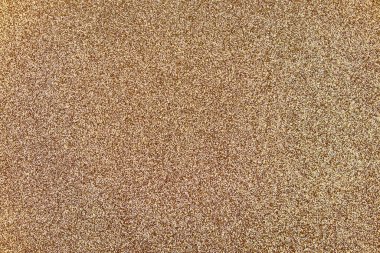 Işıldayan altın parıltılı arkaplan, ışıl ışıl parçacıklar, bayram veya kutlama tasarımları için şenlikli ve lüks bir dekoratif yüzey oluşturur.