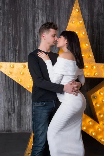 Beautiful couple in front of a glowing star. — Stock Photo, Image