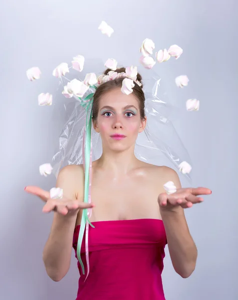 Young woman throws a candy, marshmallow — Stock Photo, Image