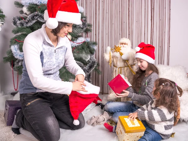 Family with gifts near a Christmas tree. — Stock Photo, Image