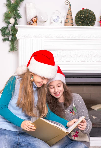 Sisters reading a Christmas story. — Stock Photo, Image