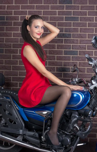 Fille en robe rouge sur une moto — Photo