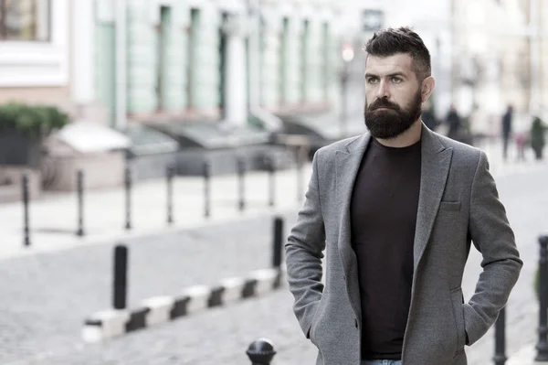 The beginning of working day. Bearded man going to work. Hipster in business style on street. Business man in modern city. Professional businessman leading busy lifestyle. Confident and successful