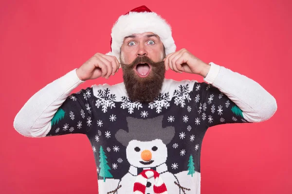 Förvånad skäggig man i varm stickad tröja och Santa claus hatt fira vintersemester av jul och känna sig glad över julklappar, överraskning — Stockfoto