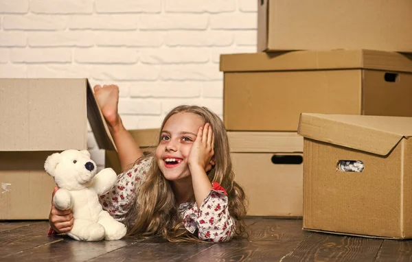 Girl small child and boxes. Delivering your purchase. Dreaming about own room. Move out concept. Kid moving out. Moving routine. Packaging things. Prepare for moving. Rent house. Real estate