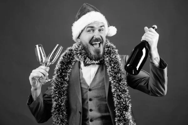 Corporate christmas party. Lets drink champagne. Boss santa hat tinsel celebrate new year or christmas. Christmas party invitation. Man bearded cheerful hipster santa hold bottle. Celebrate christmas — Stock Photo, Image