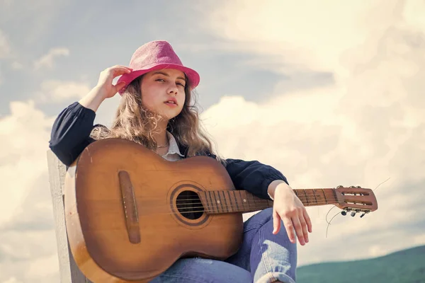 Teenage musician playing guitar. Portrait of little kid playing guitar on sky background. summer romantic playlist. Guitarist entertaining guests at party. small music lover. free music content — Stock Photo, Image