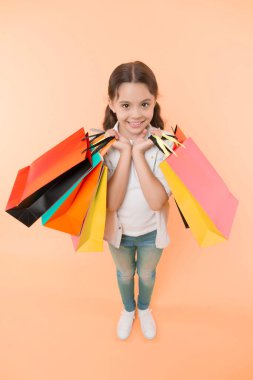 Hepsi benim için. Çocuk gülen surat, sarı arka planda paketler taşır. Doğum günü kızı konsepti. Kız hediyeleri ve doğum günü hediyelerini sever. Doğum gününü hediyelerle kutlayan çocuk.