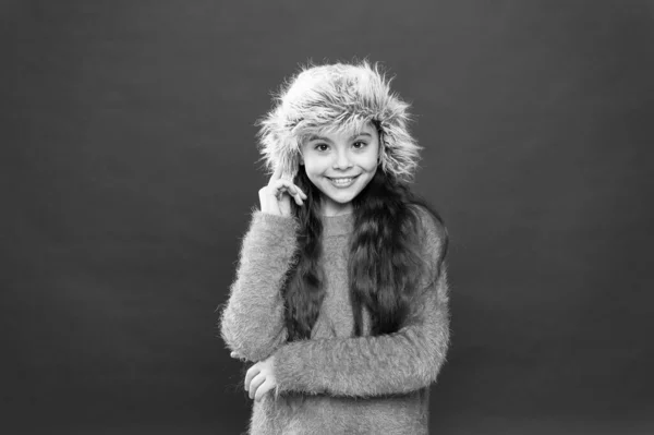 Šťastné dítě má rádo teplo. veselé děvčátko v ušním klobouku. prázdninová aktivita venku. malé dítě připravené na zimu. sezónní zdravotní péče. dětská móda. Teplé oblečení a doplňky — Stock fotografie