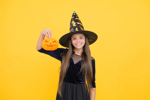 Celebrate the holidays. jack o lantern. halloween witch girl. happy childhood. teenage child in witch hat. cheerful kid holding pumpkin. carnival costume party. trick or treat. Monster of a Sale — Stock Photo, Image