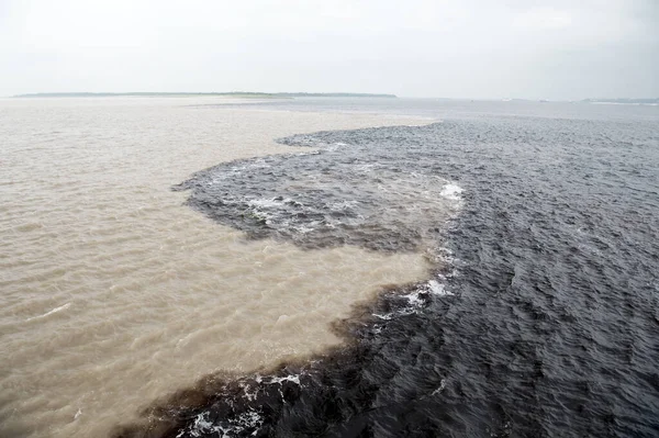 water meeting in brazil -amazon river with rio del negro