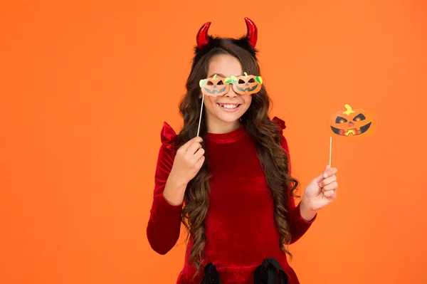 Halloween party. autumn season holidays. childhood leisure. happy halloween. kid wear devil horns. child with funny party attribute. teen girl has long hair and wear dress for holiday celebration