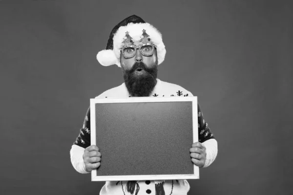 Profitable offer here. Rental services. Winter price drop. Bearded hipster Santa claus. Joyful man show blackboard copy space. Happy winter holidays. Presentation announcement. Promoting winter goods