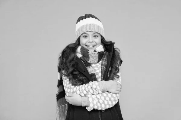 It is cold outside. Child in woolen knitted hat. Kids tend to feel cold more than adults. Winter fashion. Small girl long hair. Winter holidays idea. Winter activity for kids. Happy childhood