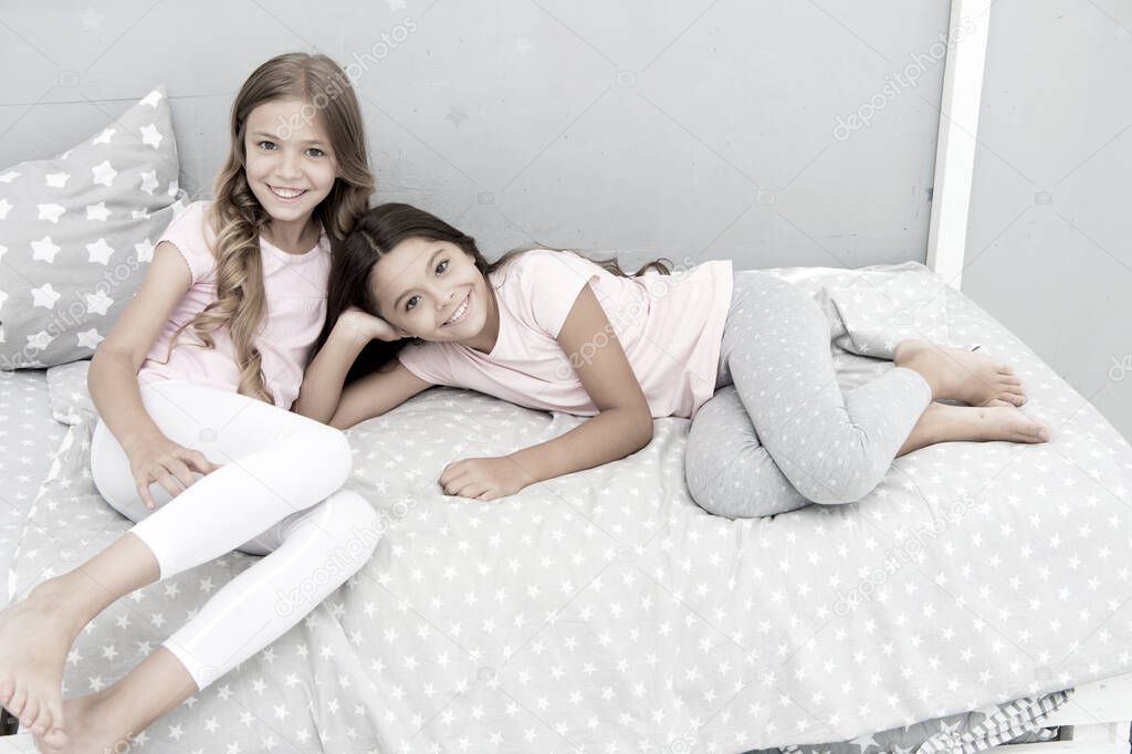 Good morning concept. Great start of day. Children cheerful play bedroom. Happy childhood moments. Joy and happiness. Happy together. Kids girls sisters best friends full of energy in cheerful mood