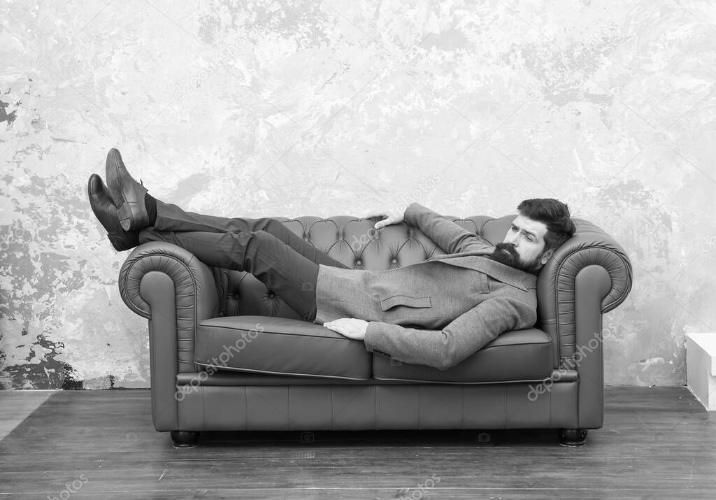 Looking good and staying in fashion. Brutal hipster relax on sofa. Bearded man with fashion look. Mens fashion and style. Casual business attire. Menswear store. Fashion as unique as you are