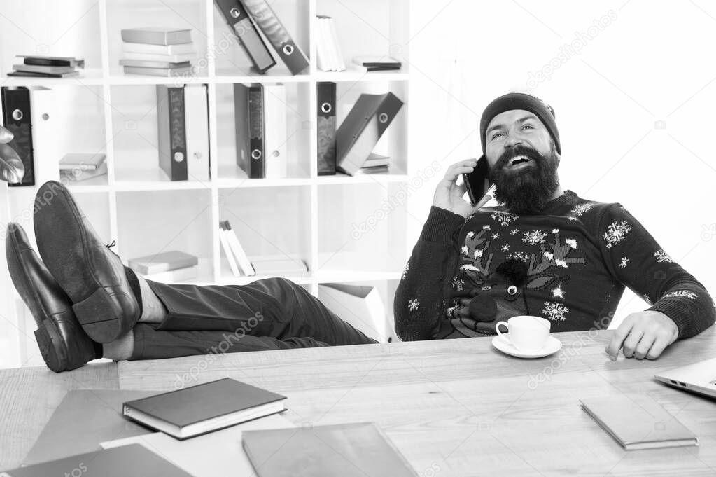 Holiday mobile marketing. Hipster talk on phone in business office. Business man in winter style. Business communication. Season greetings to customers. Well-wishing makes business work
