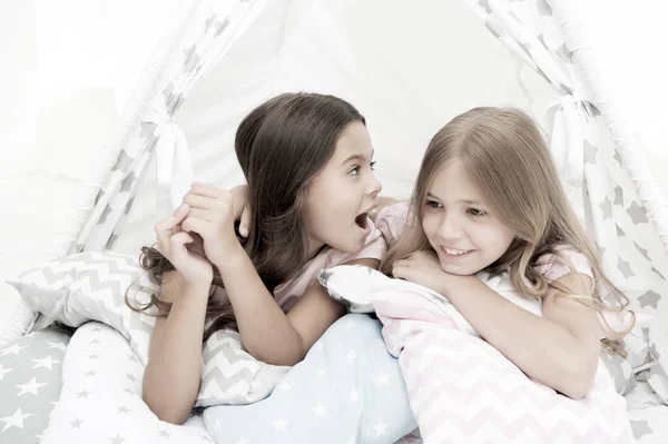 Girlish leisure. Sisters share gossips having fun at home. Pajamas party for kids. Cozy place tipi house. Sisters or best friends spend time together lay in tipi house. Girls having fun tipi house — Stock Photo, Image