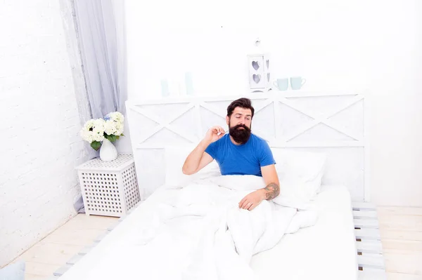 need more time. bearded man in bed has hangover. sleepy guy relax in bedroom. early morning. getting the rest your body needs. bed is so comfortable in morning. peaceful mature male relaxing