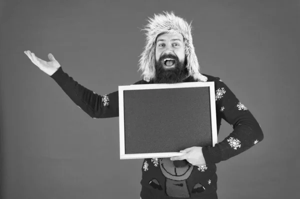 Choose your winter. Happy hipster in winter wear. Bearded man hold empty blackboard. Winter holidays. Christmas and new year activities. Cozy winter wishes, copy space — Stock Photo, Image