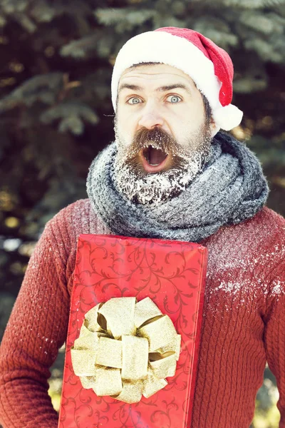 Handsome santa man with gift — Stock Photo, Image