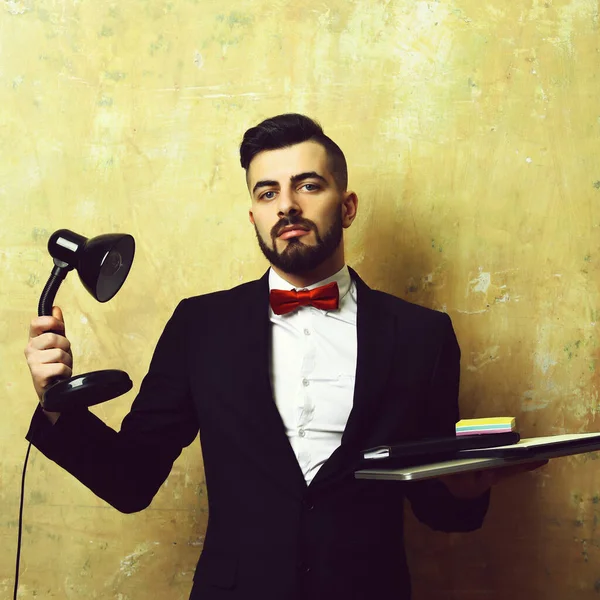 CEO with confident face expression holds lamp and laptop — Stock Photo, Image