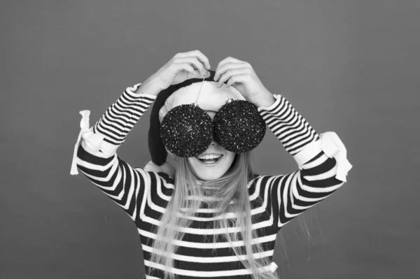 Happy smiling face. Beautiful detail. Positivity concept. Playful baby. Christmas party. Winter holidays. Playful mood. Christmas celebration ideas. Shine and glitter. Child Santa Claus costume hat