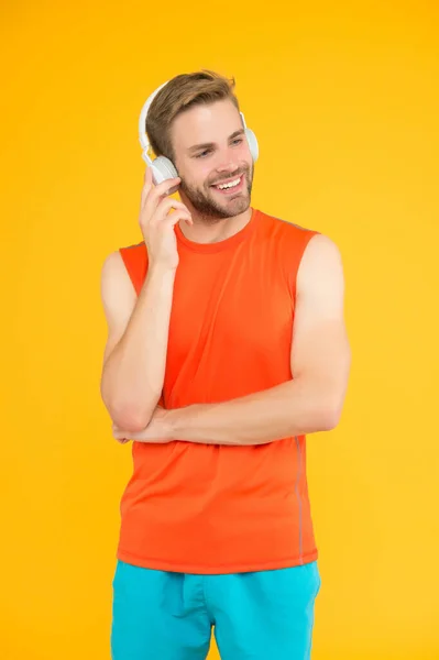 Inspirado en la canción favorita. relajarse después del entrenamiento. joven feliz con auriculares. deporte moderno y fitness. escuchar música. tipo atlético en ropa deportiva. nueva tecnología digital. entrenamiento en línea con entrenador —  Fotos de Stock