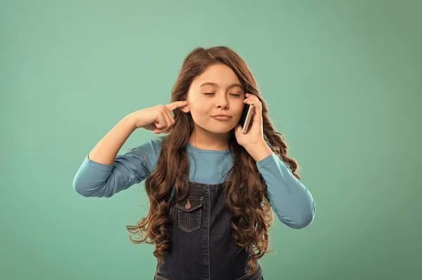 Low audibility. Mobile communication. Information and news. Modern gadget. Upbringing and development. Little girl call mobile phone blue background. Cute kid hold smartphone. Mobile conversation — Stock Photo, Image