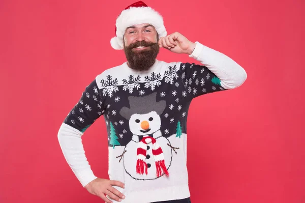 Happy bearded man touch moustache wearing funny knitted sweater and santa claus hat for celebrating new year holiday, happy new year — Stock Photo, Image