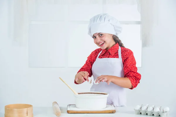 secret ingredient. culinary school. traditional cuisine. kid having fun with food at kitchen. Child and baking. Healthy eating and lifestyle. girl making dough from flour and eggs. dieting and health