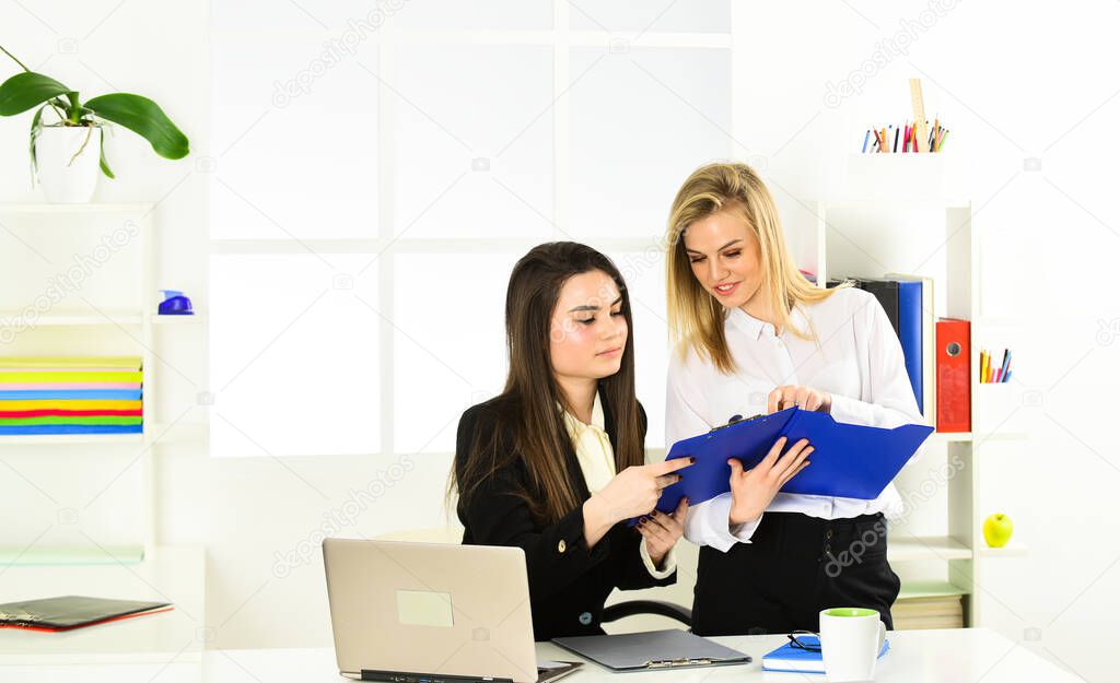 Corporate Meeting Concept. making some notes. women discuss business. modern office life. Accountant or secretary at work. boss or supervisor manager is watching at employee