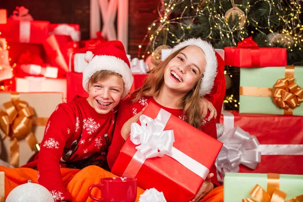 Fun in motion. family values for children. cosy winter evening together. small kids friends have fun. santa helpers among red present. too much gift. online shopping. childhood happiness and carefree — Stock Photo, Image