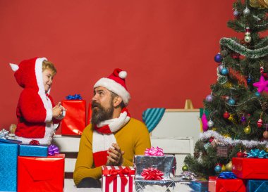 Sakallı ve gülen yüzlü bir adam oğluyla oynuyor.